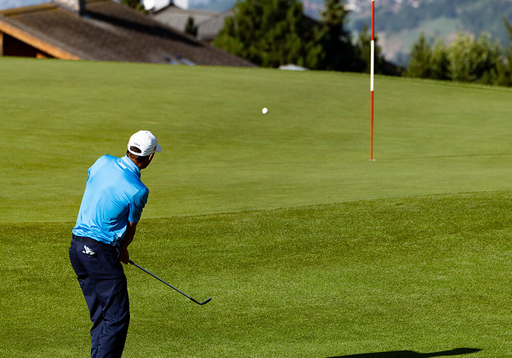 golfer wedge shot at pin