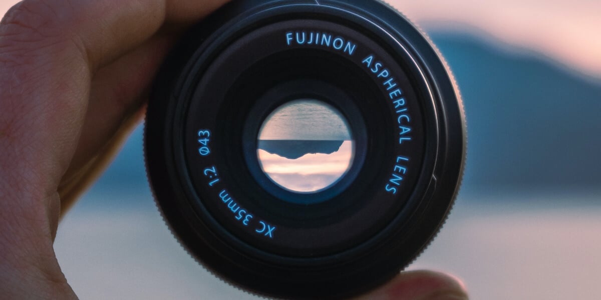 fuji lense held up against crashing waves