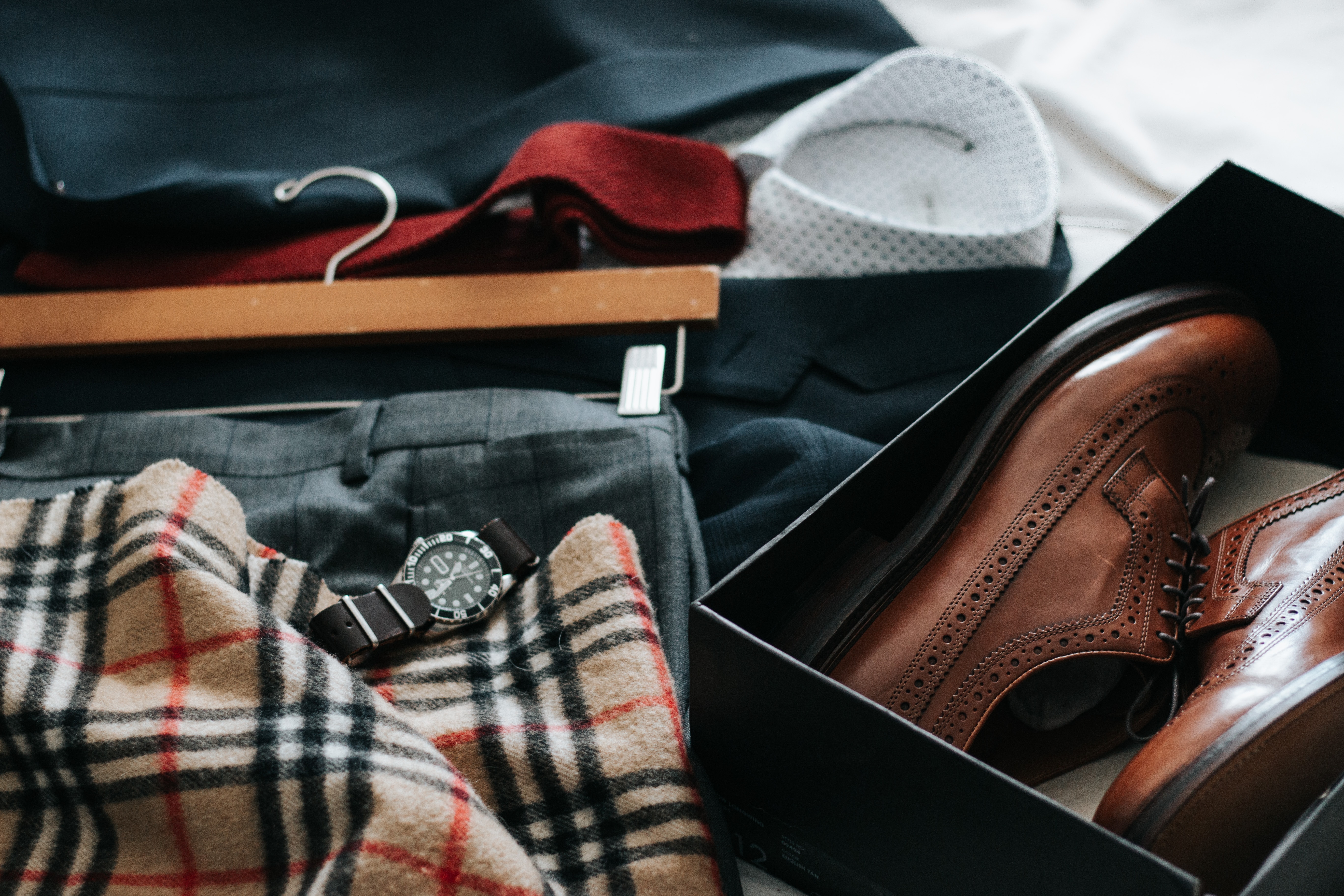 scarf, watch, and shoes on a table