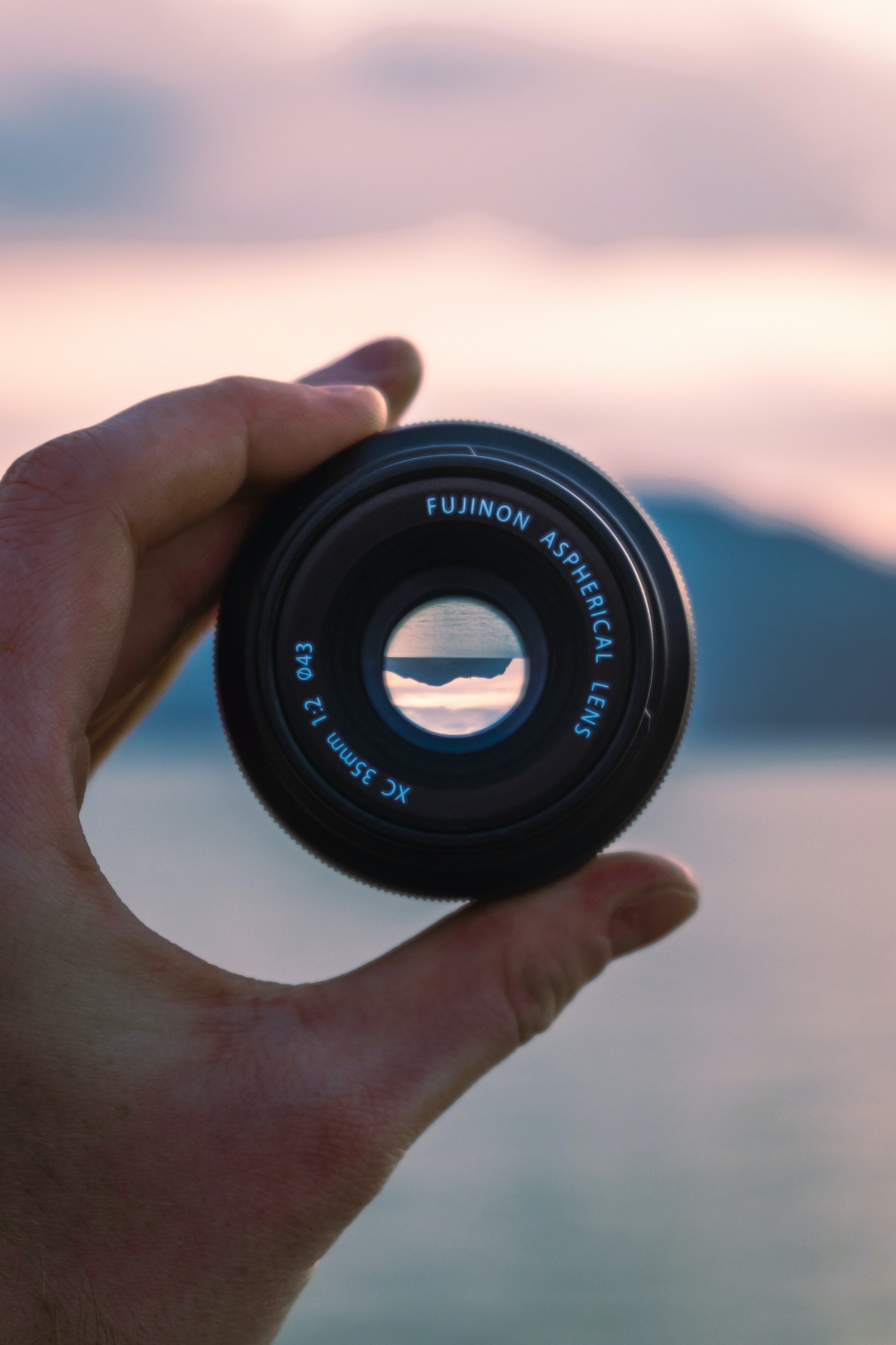 fuji lense held up against crashing waves